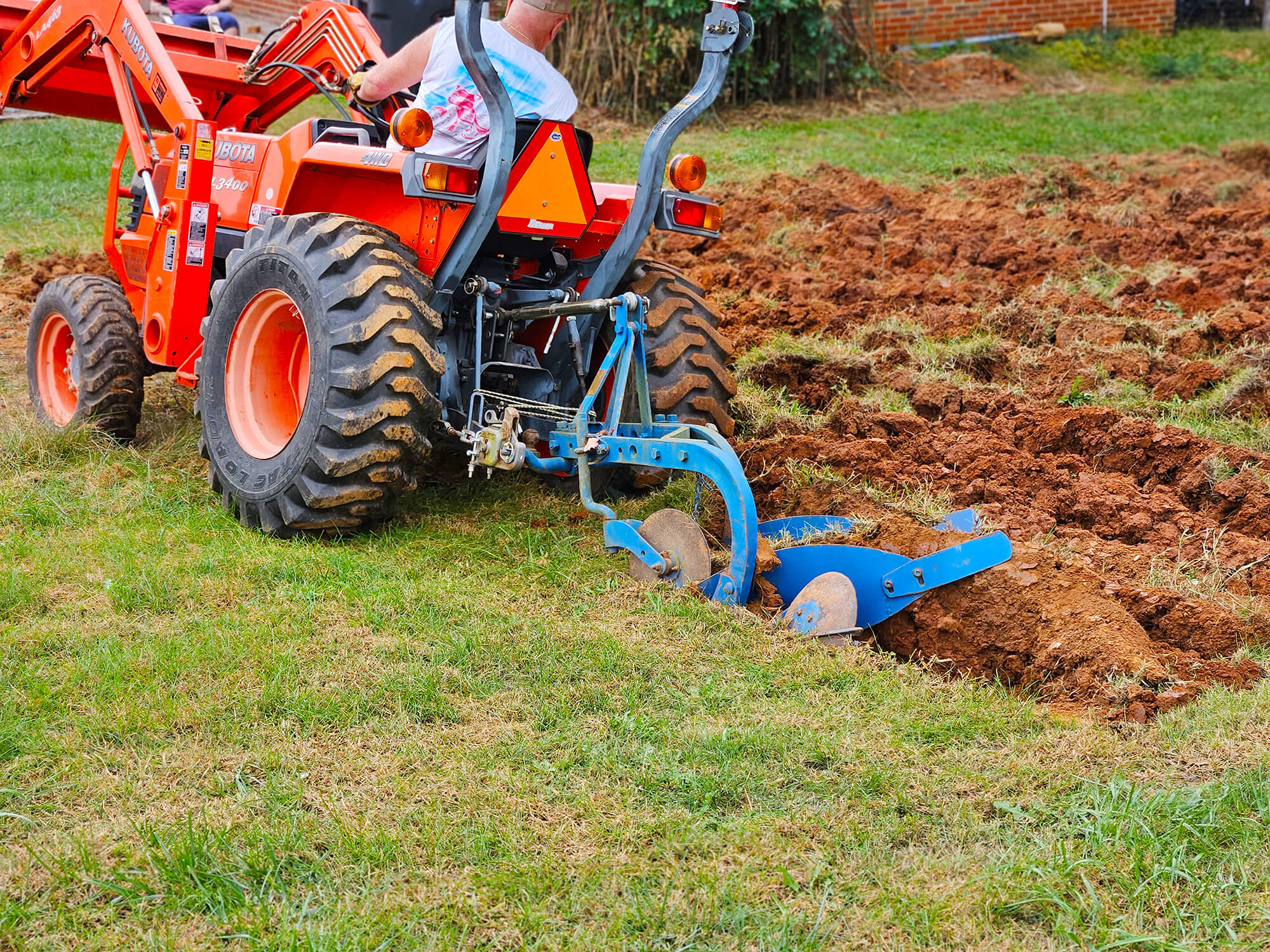 The plow hooks up to the Kubota subcompact through a category 1 three point hitch.